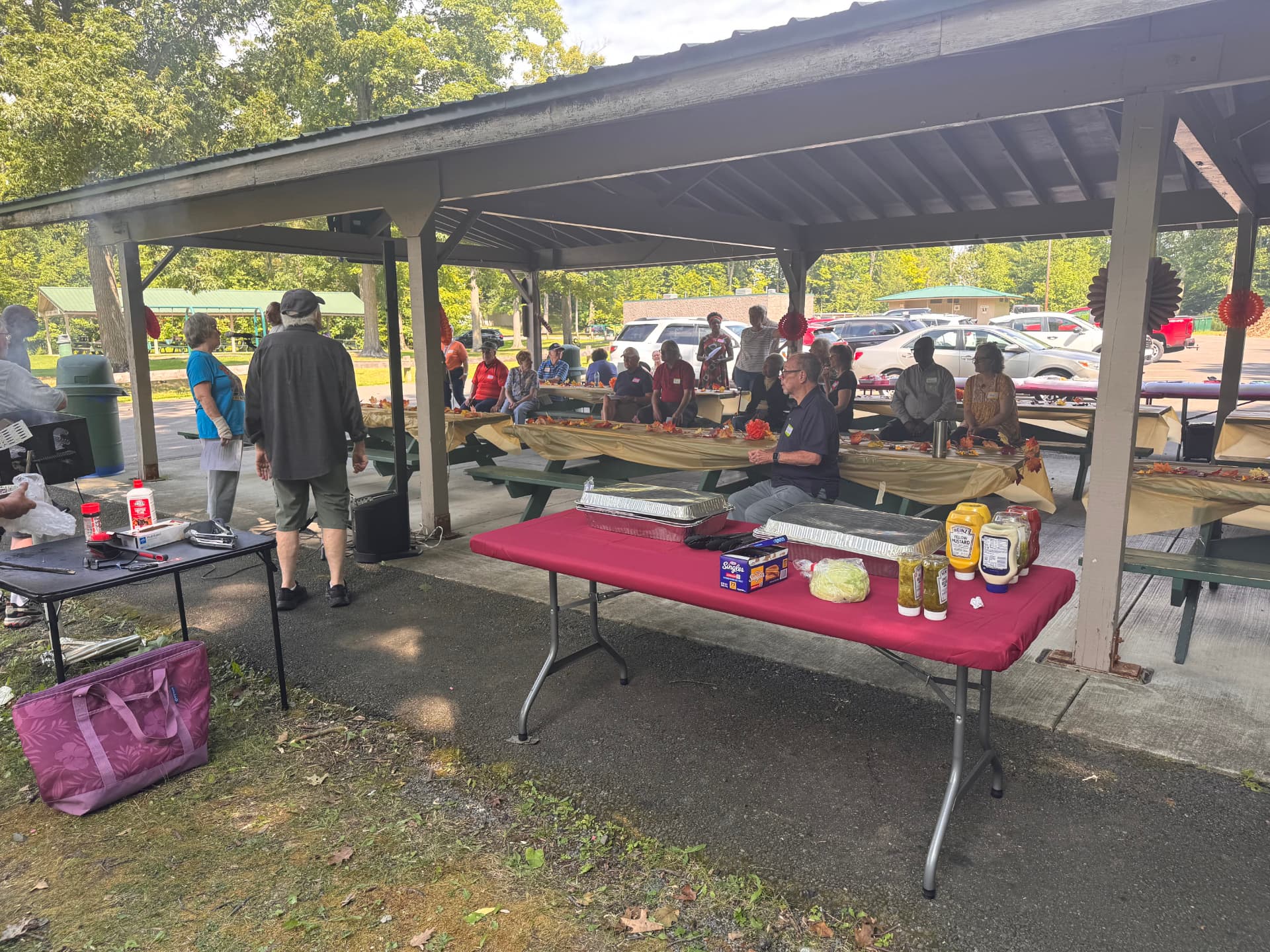 The pavilion set up with tables, grills, and picnic supplies