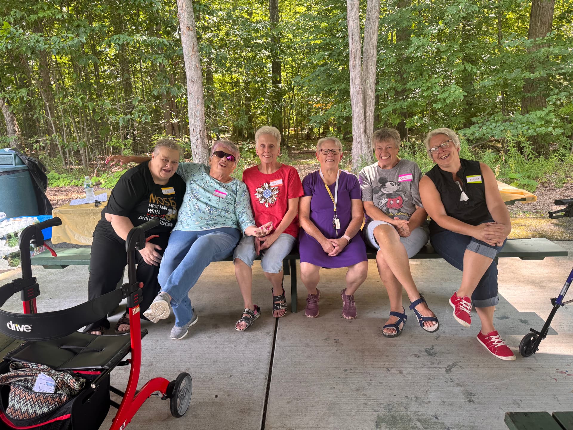Ladies of the church seated together on a pavilion bench