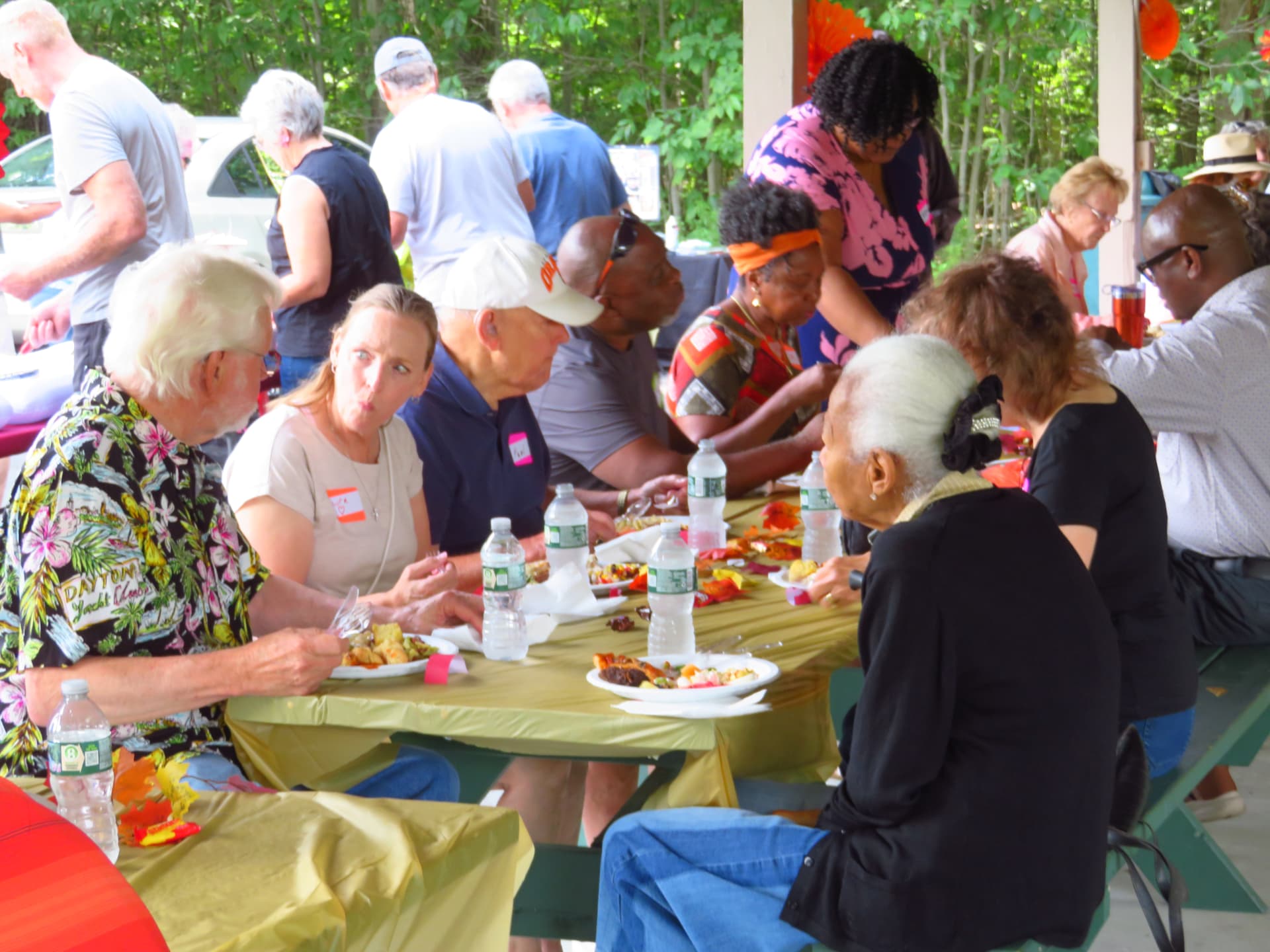 Members sharing a meal together at the pavilion tables