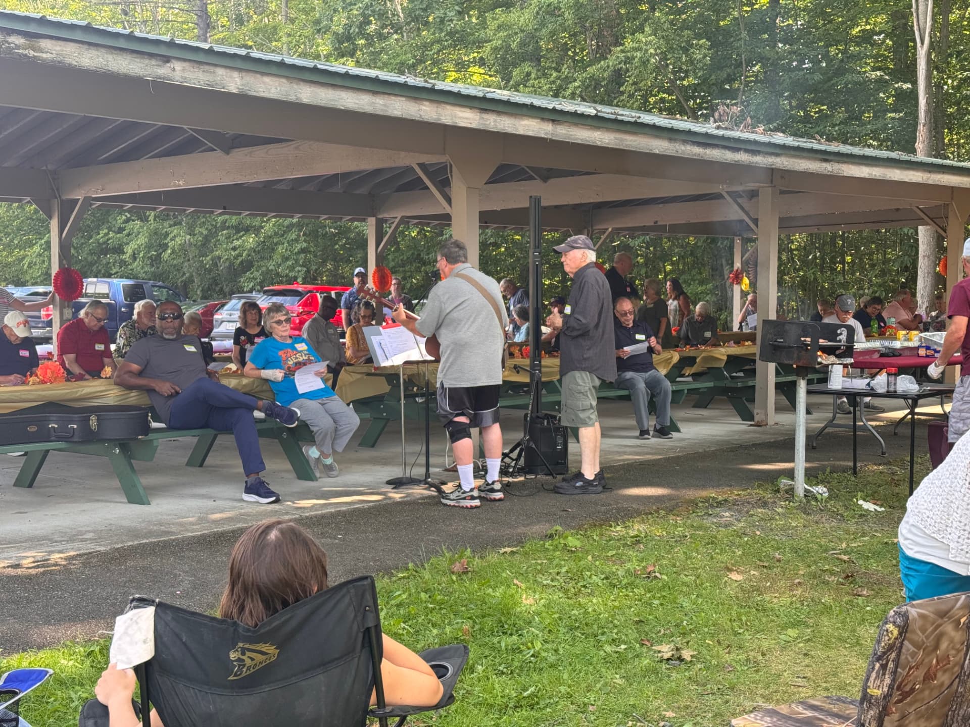 Gary McMyne leading the group in song at the picnic