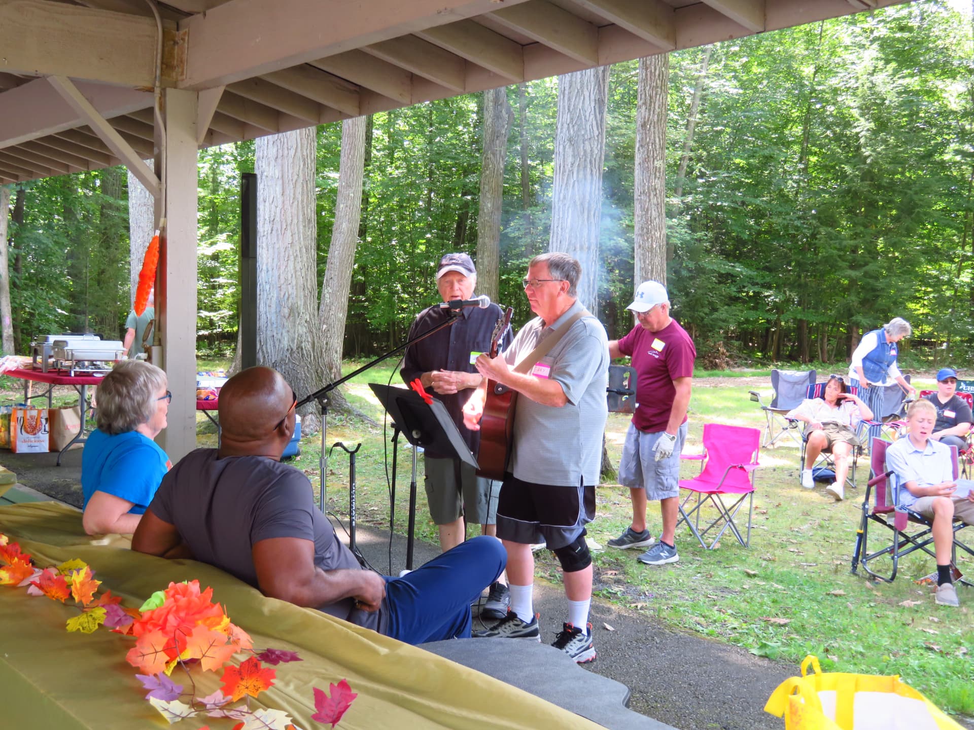 Gary McMyne and Pastor leading worship music at the pavilion