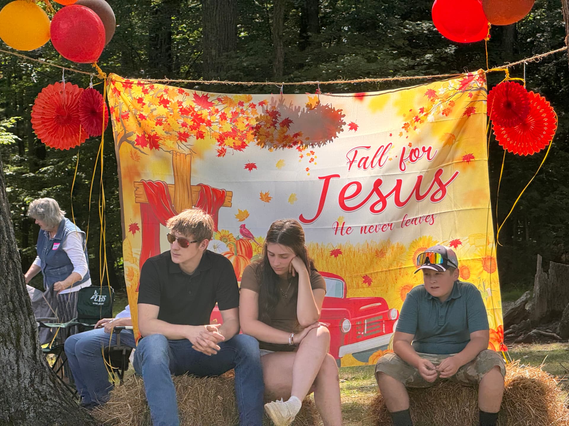 Students seated in front of a Fall for Jesus banner