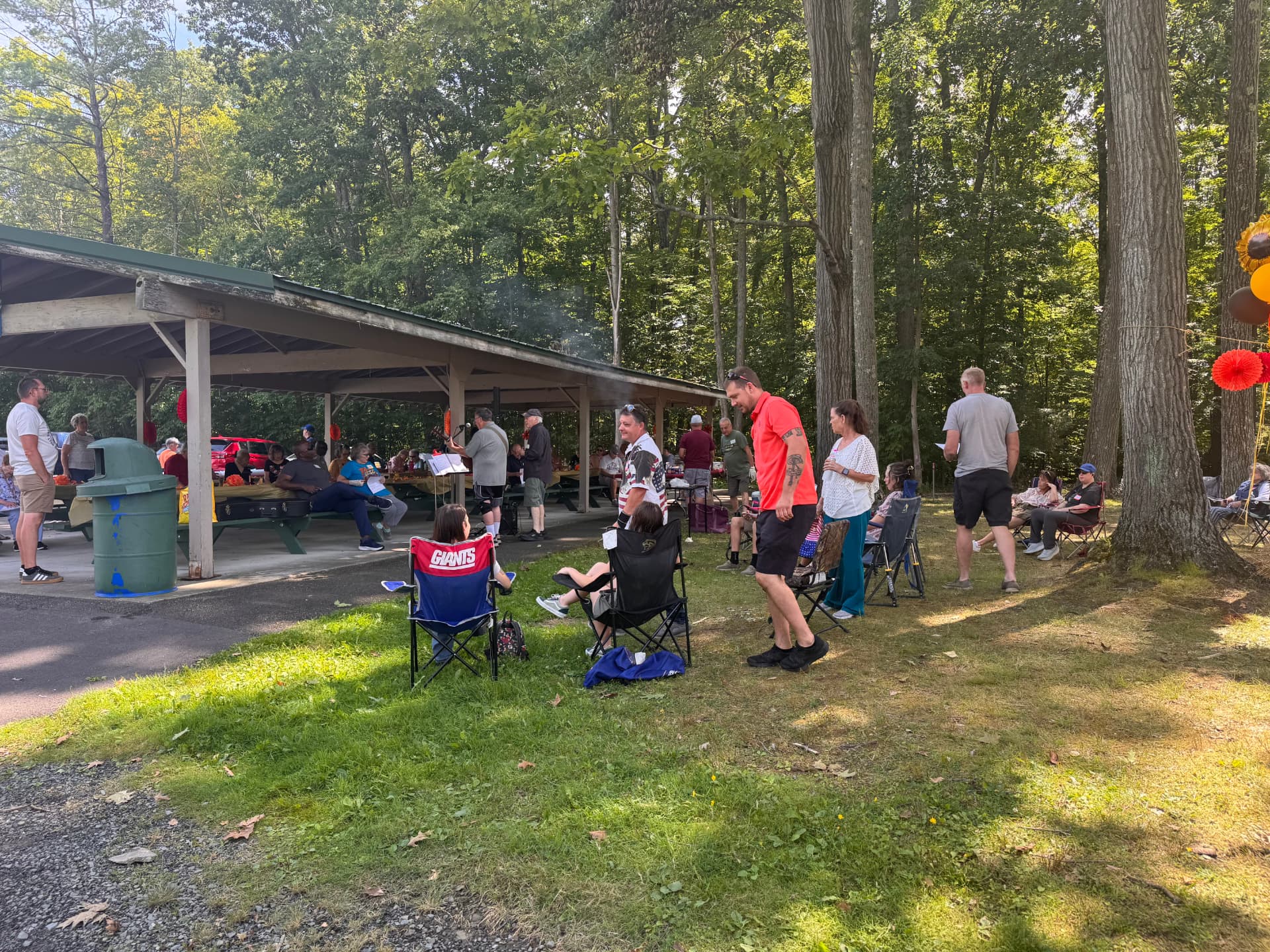 Church members gathered on the lawn beside the pavilion