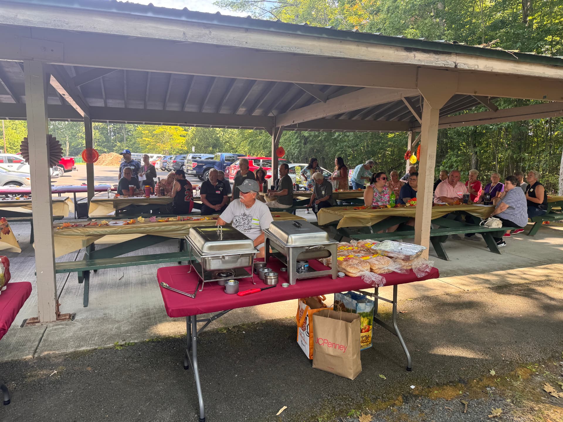 Serving tables set with food as members await the meal